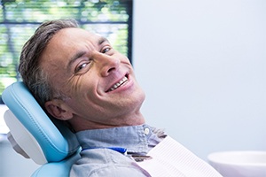 Smiling man shaking hands with dentist