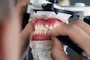 Hands of lab tech working on dentures