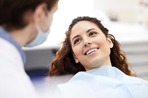 Relaxed female patient smiling during metal-free restoration appointment