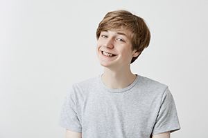 Portrait of smiling teen boy with traditional braces in East Hartford