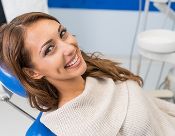 Woman in dental chair smiling