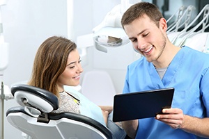 Patient and dental team member looking at tablet