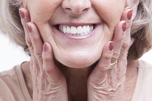 Woman showing off smile after dental bridge placement