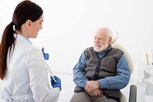 Senior man talking to dentist