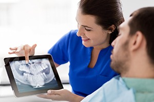 Emergency dental patient learning about his options for treatment