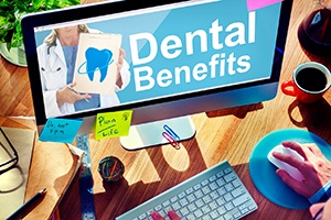 Using computer to look up information about dental insurance benefits