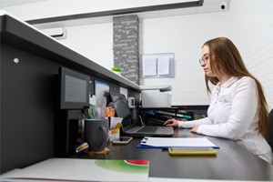 Side-view of dental office front desk team member