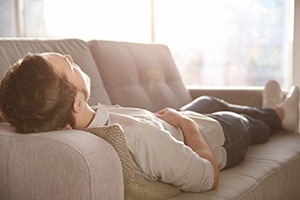 Man napping peacefully on sofa