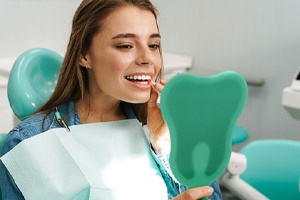 Dental patient admiring the results of gum recontouring in East Hartford