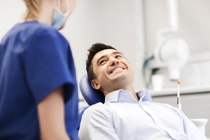 Dentist and male patient discussing gum recontouring procedure