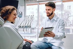 Dentist and patient discussing the cost of gum recontouring