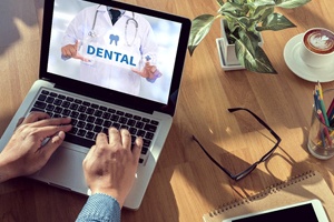 Patient looking up dental insurance information on computer