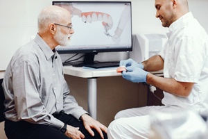 Dentist and patient discussing patient’s candidacy for implants