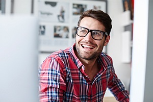 Man sharing healthy smile after dental implant tooth replacement