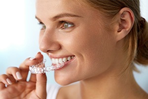 Woman placing Invisalign tray