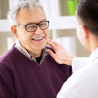 Man smiling after periodontal plastic surgery