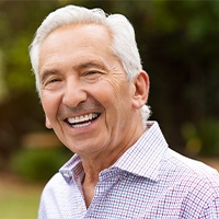 Man smiling after dental implant tooth replacement