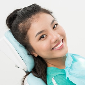 Smiling woman in dental chair for preventive dentistry