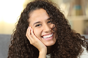 Youn woman with healthy smile after fluoride treatment