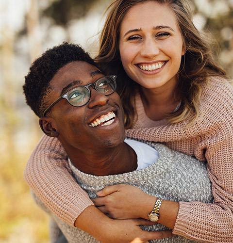 Smiling man and woman outdoors