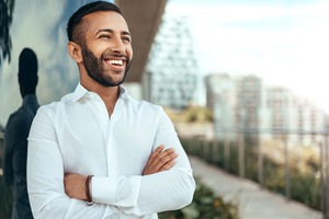 Young man smiling confidently after teeth whitening service