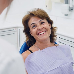 Happy patient looking up at her dentist