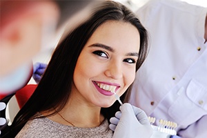 Woman smiling during porcelain veneer treatment