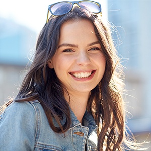 Young woman sharing healthy smile after wisdom tooth extraction