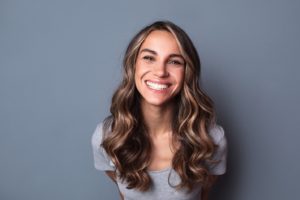 woman enjoying benefits of smile makeover in East Hartford