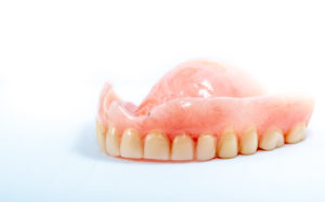 Stained denture in East Hartford against white background