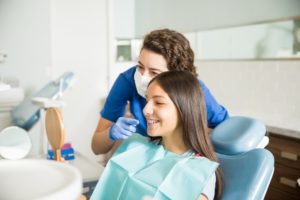 Woman smiling after getting her broken braces repaired