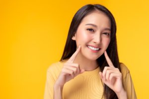 Woman showing bright smile after using free teeth whitening kit