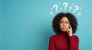 Woman wearing curious expression, question marks above her head 