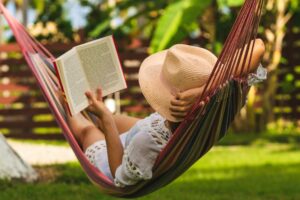 Woman reading a book outside during summer 
