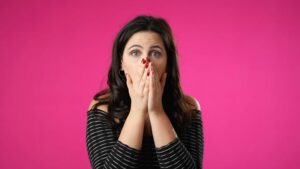 Concerned woman covering her mouth 